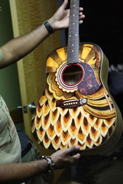Michael Franti's guitar painted by Clark Hipolito