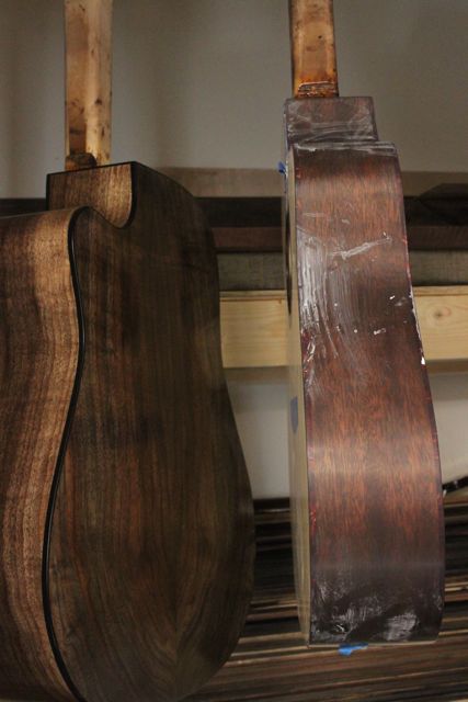 Claro walnut and cedar cutaway guitars in the spray booth